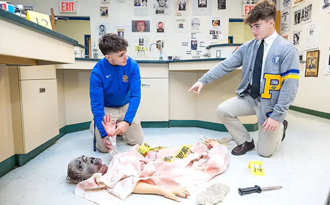 2 students reviewing a crime scene