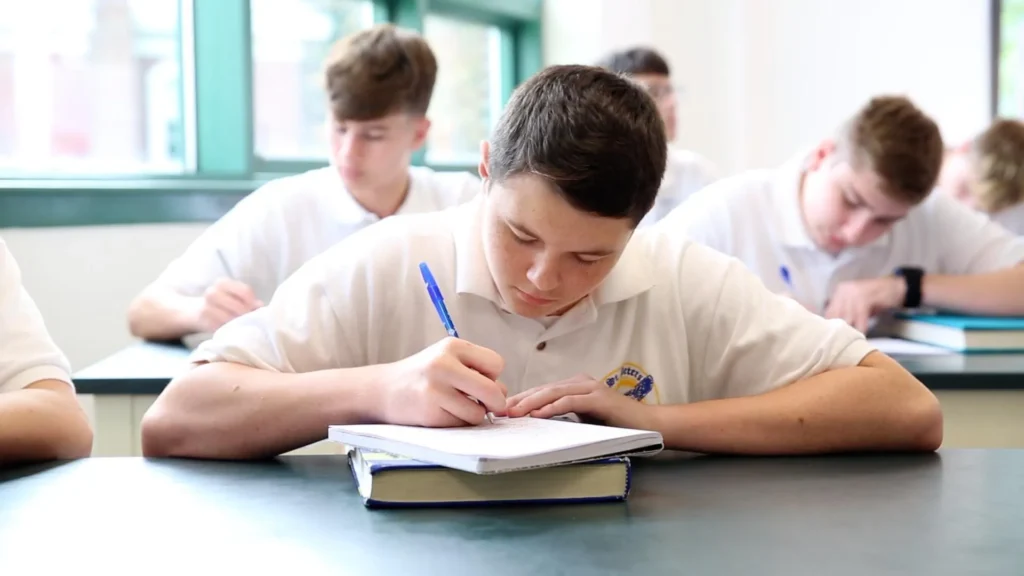 A student writing in a notebook