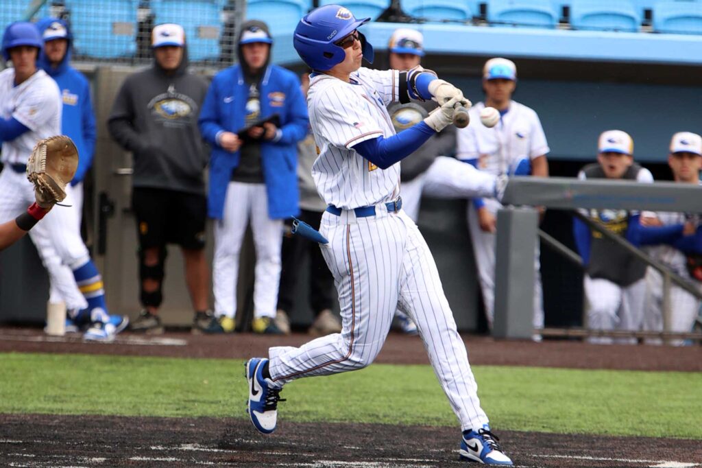 baseball player swinging at a pitch